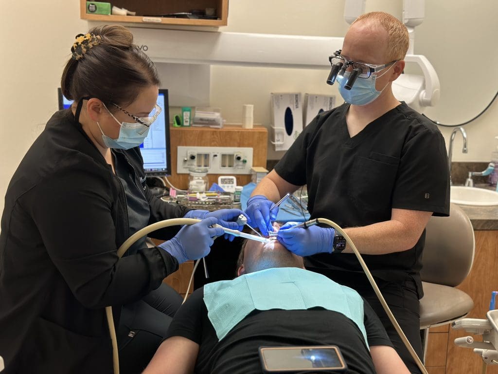Dr. Brandon Dawson and dental assistant providing patient care