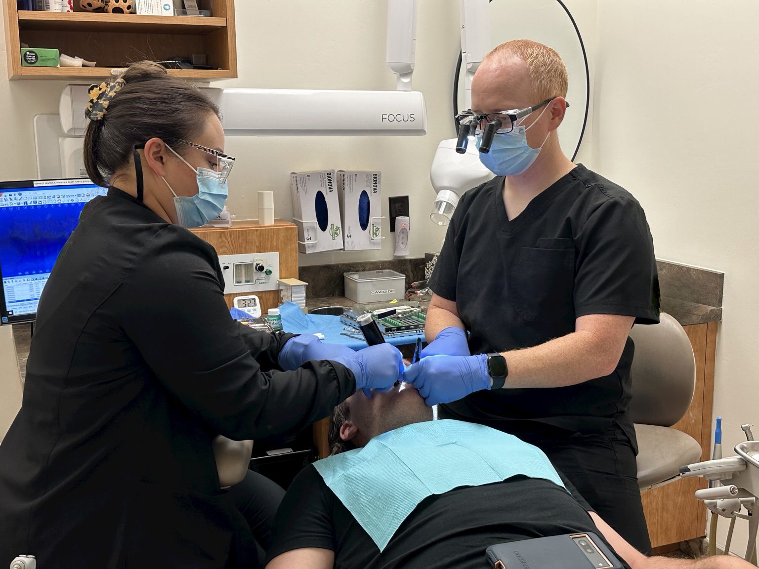 Dr. Brandon Dawson and a dental assistant providing patient care